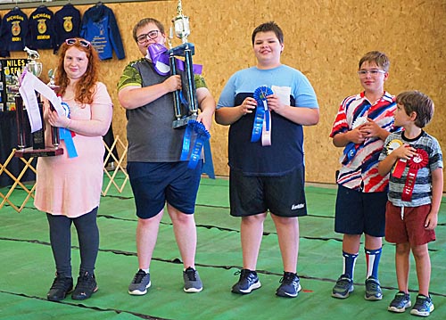 4-H'ers with trophies and ribbons