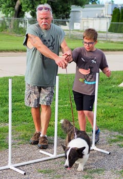 A 4-H'er, a volunteer leader, and their team canine.