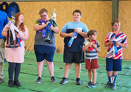 4-H'ers and their fair trophies